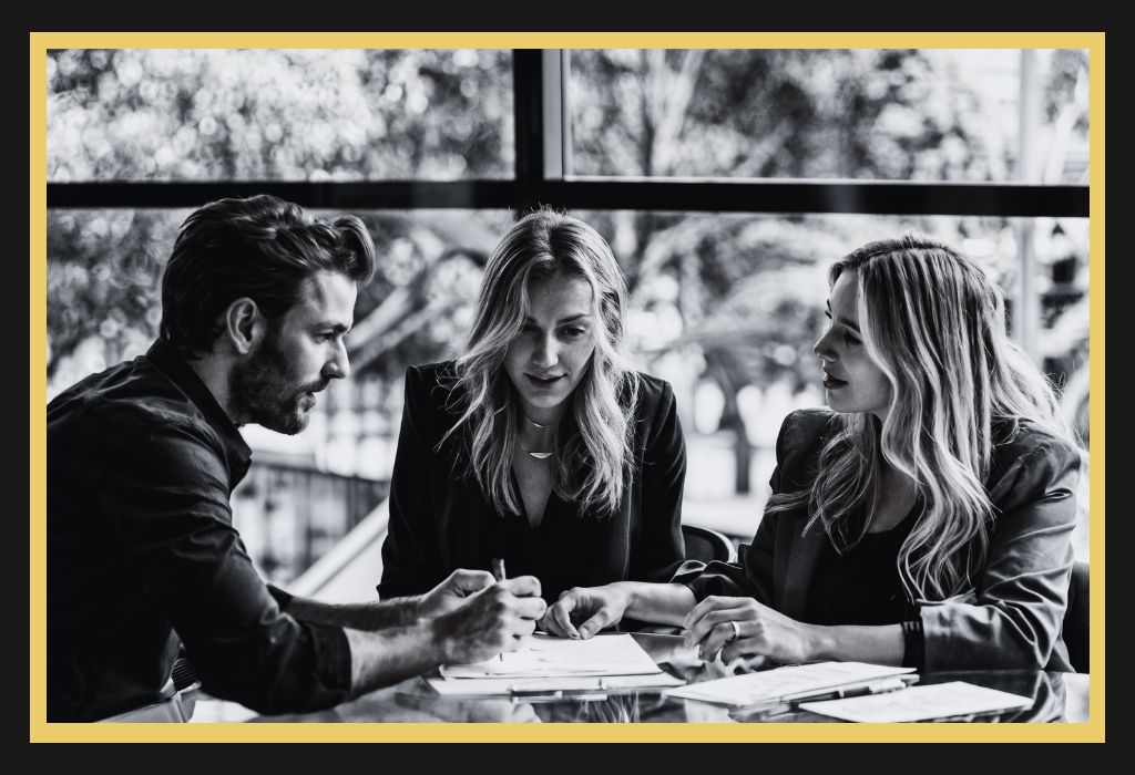 Couple reviewing a financially binding agreement with a lawyer during a consultation in Sydney